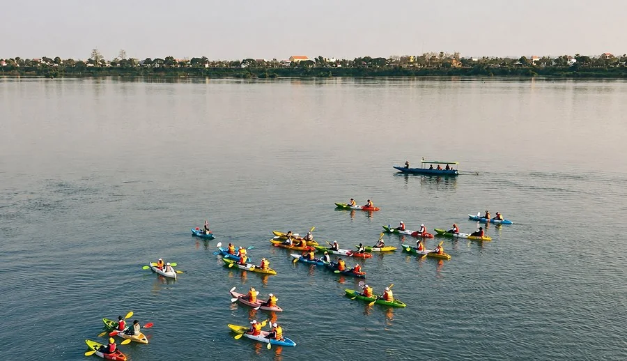 Kayakers on the river at dusk near Stung Treng
